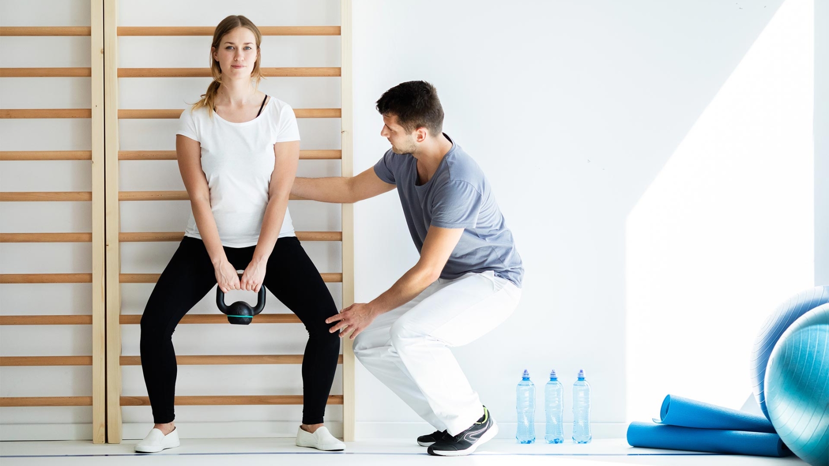 professional-physician-helping-his-patient-exercis-FZJZ9FH-1.jpg