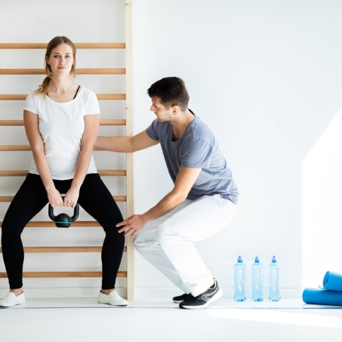 professional-physician-helping-his-patient-exercis-FZJZ9FH-1.jpg